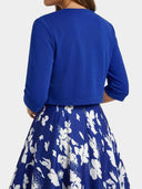 Blue floral maxi dress with cropped royal blue bolero, back view.