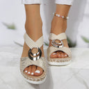 Beige woven platform espadrille sandals with metallic ring accent and cross-strap ankle wrap, front angled view on model, natural jute sole detail.