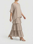 Taupe tiered chiffon mini dress with long sleeves, side view on a white background.
