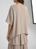Taupe mini dress with short sleeves and tiered skirt, back view.