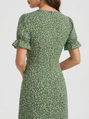 Green floral mini dress with puff sleeves and ruffled cuffs, back view.