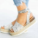 White espadrille flatform sandals with ankle strap and woven jute platform sole, styled on-foot view.