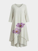 Light beige maxi dress with purple floral print, V-neck, and layered hem, front view.