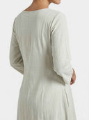 Light grey maxi dress with long sleeves and textured fabric, back angled view.