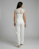 White jumpsuit with lace cap sleeves and lace back, rear view on a light gray background.