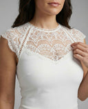 White jumpsuit with lace yoke and cap sleeves, detail shot.