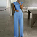 Light blue jumpsuit with lace cap sleeves and wide pleated legs, front view.