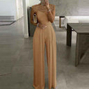 Tan jumpsuit with lace cap sleeves, wide legs, front view.