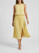 Yellow sleeveless maxi dress with pleated skirt and side slit, front view on white background.