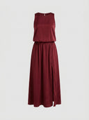 Burgundy sleeveless maxi dress with elastic waist and side slit, front view on white background.