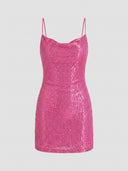 Pink sequin mini dress with spaghetti straps and cowl neck, front view on gray background.
