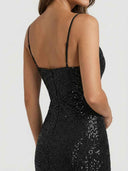 Black sequin mini dress with spaghetti straps and back zipper, angled back view.