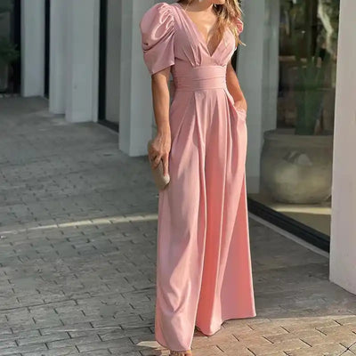 Pink jumpsuit with puffed sleeves, V-neck, and wide legs, front view.