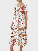 White floral mini dress with short sleeves and scoop neck, angled front view.