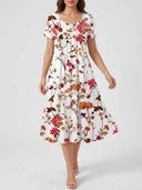 White floral mini dress with short sleeves, scoop neck, and gathered waist, front view.