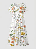 White mini dress with colorful floral print, short sleeves, and round neck, front view.
