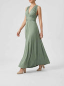 Sage green maxi dress with V-neck and wrapped waist, angled side view on white background.