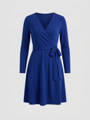 Royal blue long sleeve wrap mini dress with V-neck and waist tie, front view.