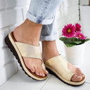 Cream textured open-toe wedge mule sandals with wide single toe-band and brown-toned sole, angled front view on white background.