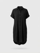 Black textured mini shirt dress with short cuffed sleeves and pockets, front view on white background.