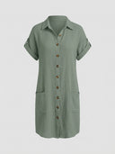 Sage green textured mini shirt dress with rolled short sleeves and front pockets, front view.