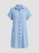Light blue textured mini shirt dress with short sleeves, front pockets, and brown buttons, front view.