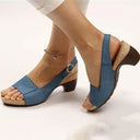Blue peep-toe slingback sandals with cork block heel and ankle strap, worn on feet, side view.