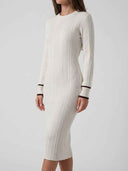 Cream ribbed mini dress with long sleeves and brown striped cuffs, angled view.