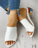 White crocodile-texture open-toe mule sandals with jewelled block heel, styled with distressed blue jeans, overhead view.