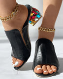 Black crocodile-texture open-toe mule sandals with jewelled block heel, angled side view styled with gold chain anklets.