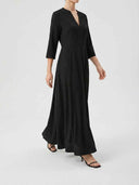 Black maxi dress with V-neck, 3/4 sleeves, and pleated skirt, angled view.