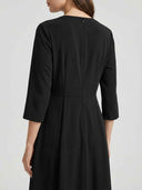 Black maxi dress with 3/4 sleeves, back zipper, and pleated waist, shown from the back.