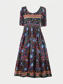 Navy blue tiered mini dress with floral print and striped trim, front view.