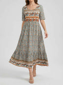 Bohemian tiered mini dress with floral print, short sleeves, and banded trim, front view.