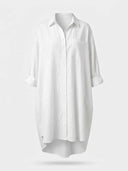 White mini sundress with collar, rolled sleeves, and chest pocket, front view.