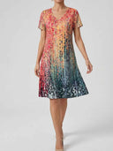 Long sleeve mini dress with multicolor abstract print, V-neck, front view.