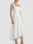 White square neck A-line mini dress with high-low hem, angled front view.