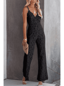 Black lace jumpsuit with spaghetti straps, V-neck, and wide legs, front view on a gray background.