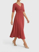 Rust midi wrap dress with V-neck and short sleeves, angled view on white background.