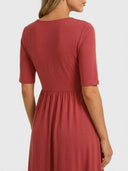 Rust midi dress with short sleeves and gathered waist, back view.