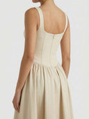 Beige sleeveless corset midi dress, back view with zipper detail.
