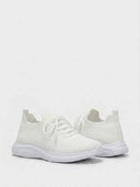 Women's white supportive walking trainers with flat laces and thick rubber outsole, angled view on white background.