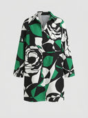 Black, white, and green abstract floral print mini dress, front view on a white background.