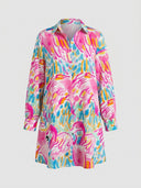 White mini dress with colorful flamingo and abstract print, long sleeves, front view.