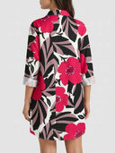 White mini dress with pink, black, and gray floral print, back view.