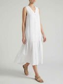 White sleeveless V-neck midi dress with buttons and tiered skirt, front view.