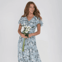 Light blue botanical print maxi dress with flutter sleeves, front view on white background.
