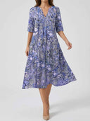 Purple tiered mini dress with floral pattern, front view on white background.