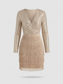 Gold sequin mini dress with long sleeves and tiered fringe skirt, front view.