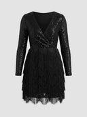 Black sequin mini dress with long sleeves and tiered fringe skirt, front view on a white background.